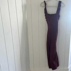 Cutest jump suit! Has a sweet detail of flowers on it, a little above ankle.